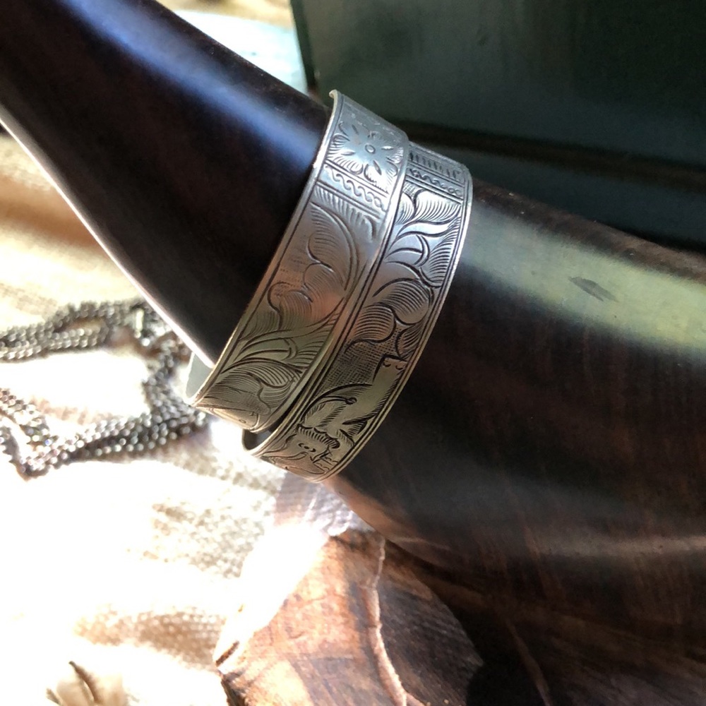 elephant and fish engraved pair of cuff bracelets